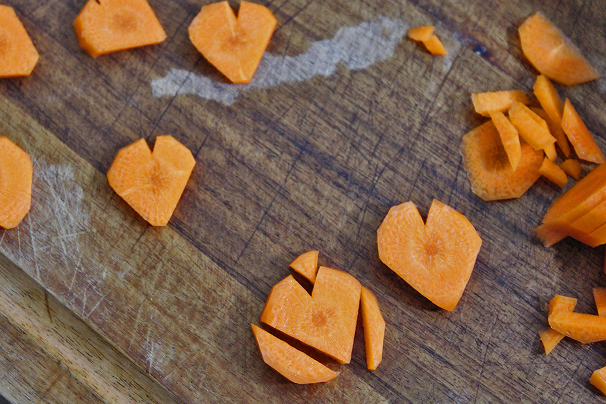 Closeup of carrots cut into heart shapes.